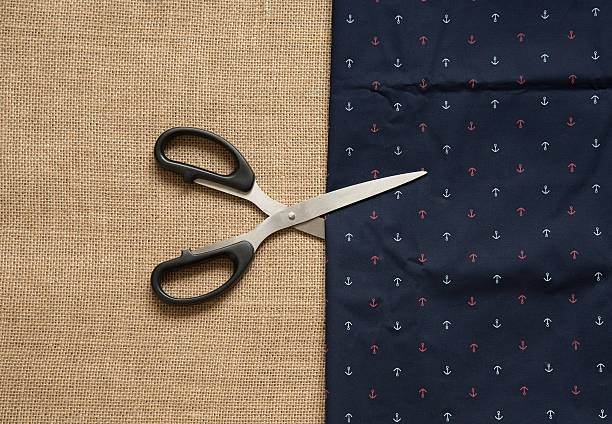 istock Metal scissors , and blue fabric with anchor ornament 509037340