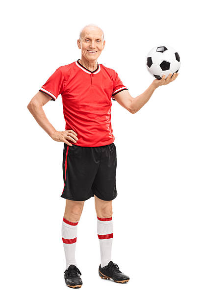 istock Senior man holding a football and smiling 509041784