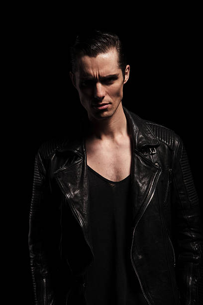 istock latin biker in black leather jacket posing in dark studio 509041808