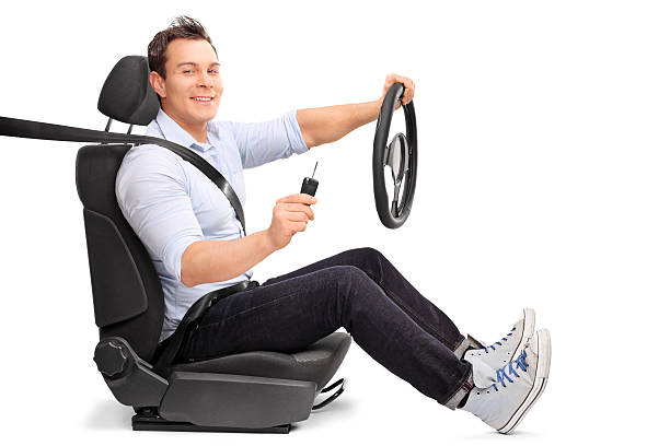 istock Man holding a steering wheel and a car key 509042304