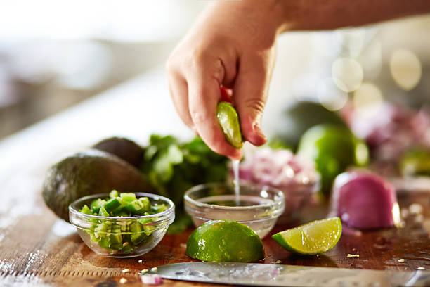 istock squeezing lime juice for guacamole recipe prep 509046314