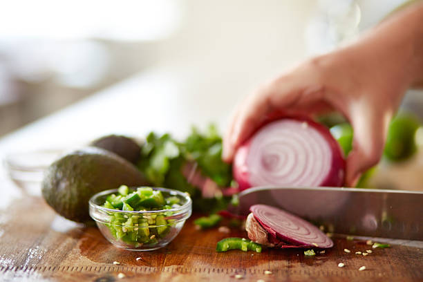 istock cutting red onion on wooden board i 509046378