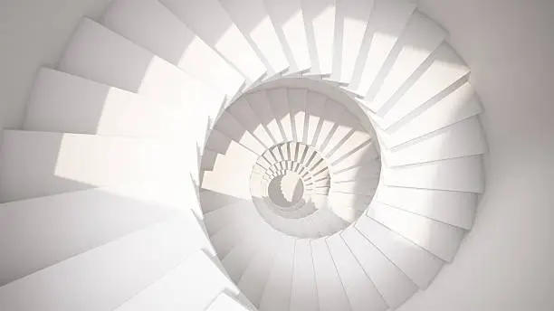 Photo of White spiral stairs in sun light abstract interior