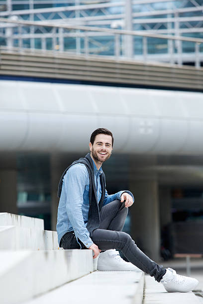istock Happy young man sitting outdoors 509047413