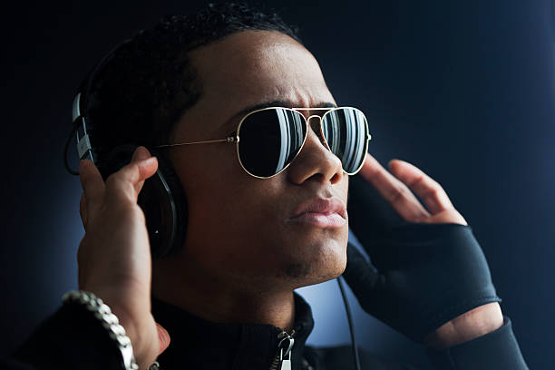 istock Young man with headphones and sunglasses _ horizontal 509047513