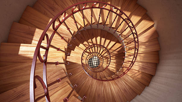 istock Wooden spiral stairs with rails in sun light interior 509047894