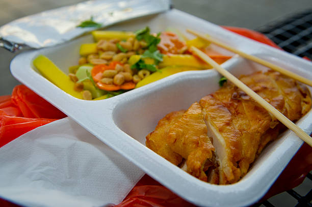 Bento box with onigiri with chicken filling and vegetables. toning