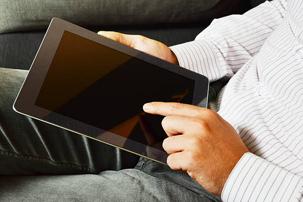 istock Adult man using digital tablet at home 509050357