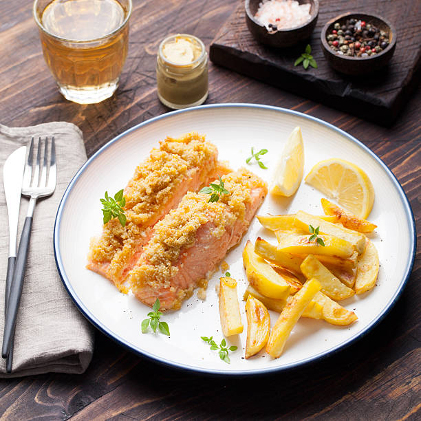 istock Fish salmon with baked potatoes and lemon slices 509051238