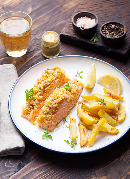 istock Fish salmon with baked potatoes and lemon slices 509051272