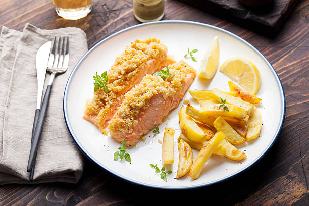 Fish salmon with baked potatoes and lemon slices