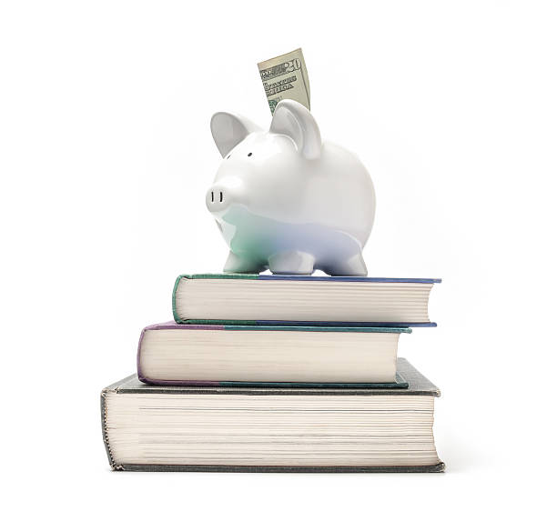 Piggy bank on a stack of books stock photo