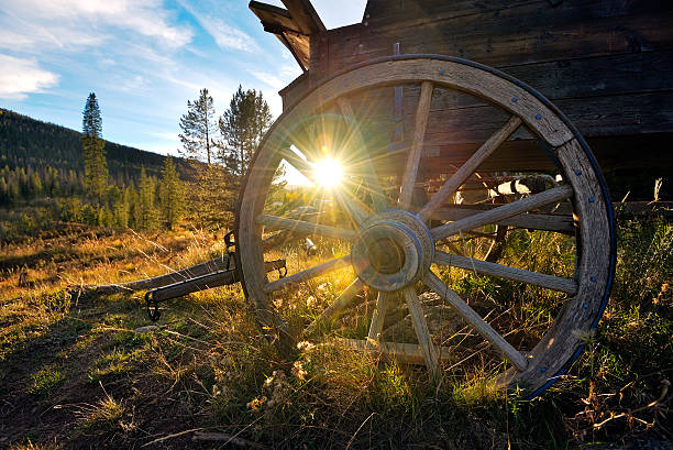 Wagon Wheel Antique Mountain Wagon at sunset near Vail Colorado covered wagon stock pictures, royalty-free photos & images