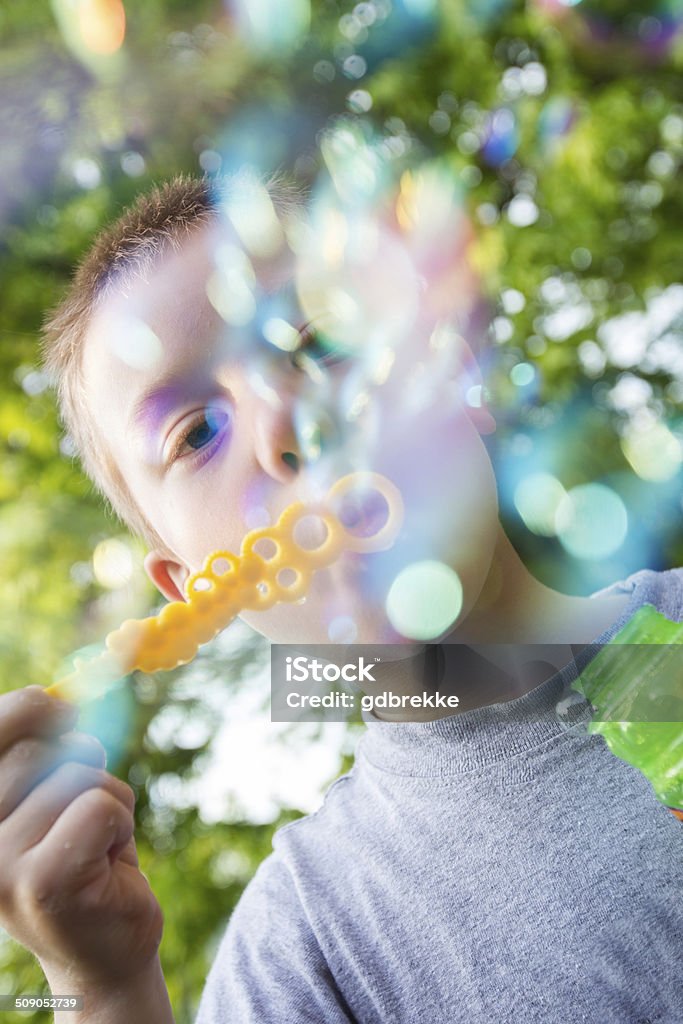 Blowing Bubbles A young blond boy blows bubbles Blond Hair Stock Photo