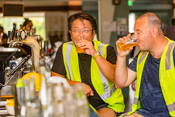 istock Workmen Relaxing With Beer After Work in High Visibility Clothes 509053252