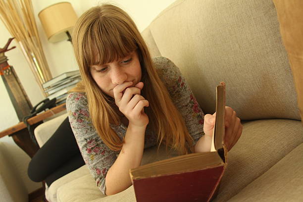 Young woman reading on couch