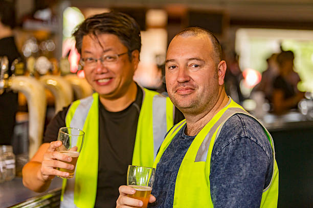 istock Workmen Relaxing With Beer After Work in High Visibility Clothes 509053800