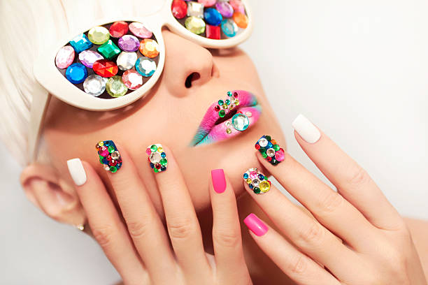 Makeup and manicure with crystals. Makeup and manicure with multicolored crystals and glasses on the blonde girl. fingernail photos stock pictures, royalty-free photos & images