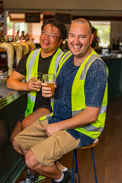 istock Workmen Relaxing With Beer After Work in High Visibility Clothes 509054266
