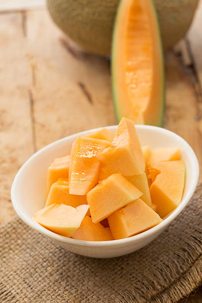 istock Fresh melons sliced in a bowl on old wooden table. 509054774