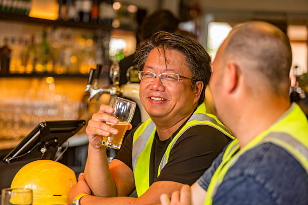 istock Workmen Relaxing With Beer After Work in High Visibility Clothes 509055054