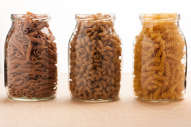 istock Wheat buckwheat and spelt pasta separated in three glass jars. 509055420