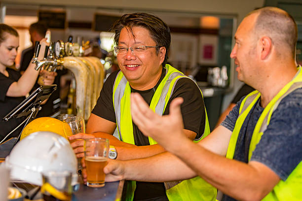 istock Workmen Relaxing With Beer After Work in High Visibility Clothes 509055964