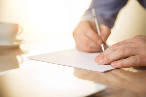 istock The male hands with a pen and the cup 509057188