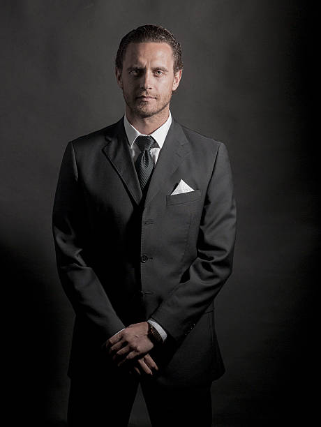 istock young handsome businessman standing on dark background 509075387