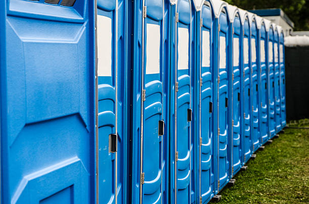 Row of chemical and portable toilets Row of blue chemical and portable toilets for an outdoor party portable toilet stock pictures, royalty-free photos & images