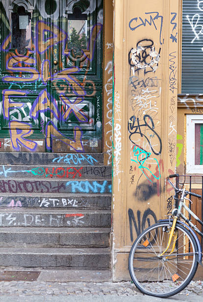 istock Berlin - house entrance with graffiti paintings and bicycle 509080047