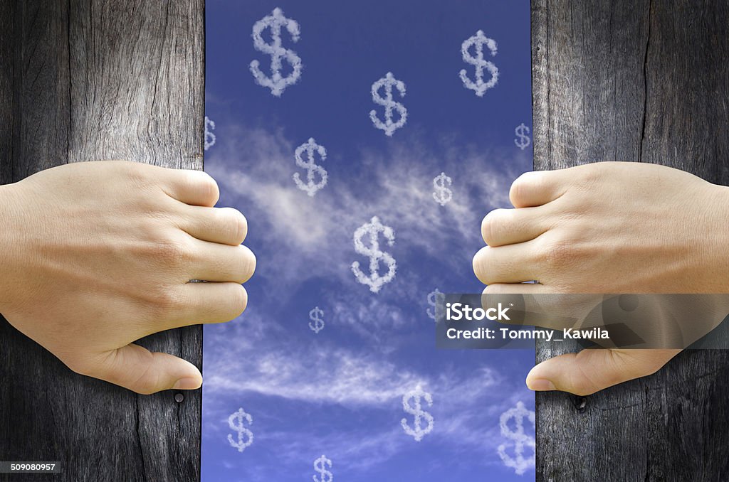 Dollar signs text cloud in the Sky. Hand opening the wooden door and see "Dollar signs" text cloud in the Sky. Adult Stock Photo