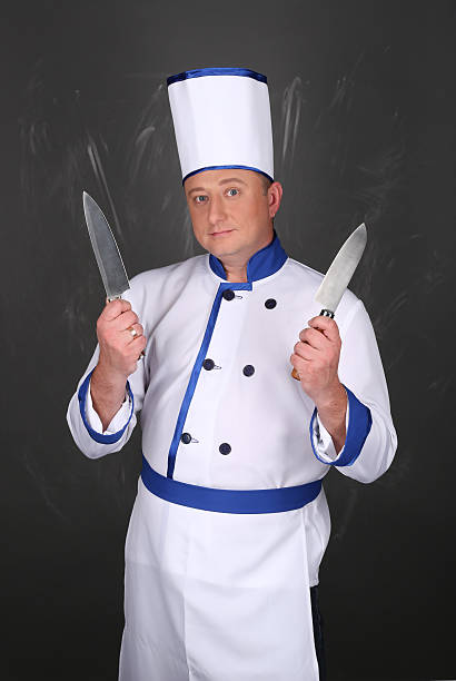 istock Chef wearing workwear and holding a knife 509090694