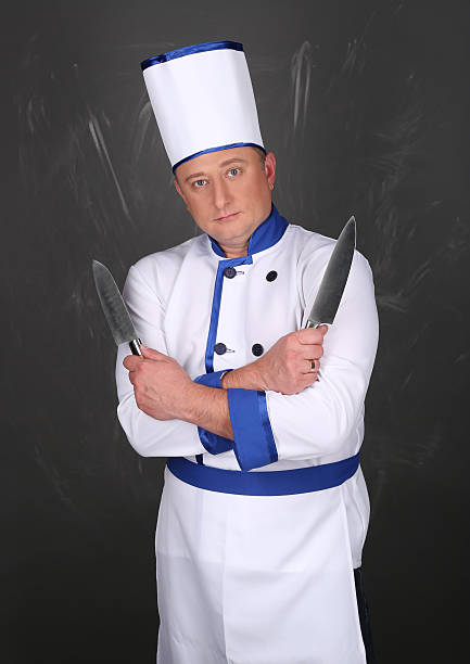 istock Chef wearing workwear and holding a knife 509090728