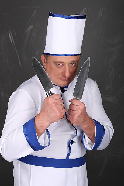 istock Chef wearing workwear and holding a knife 509090874