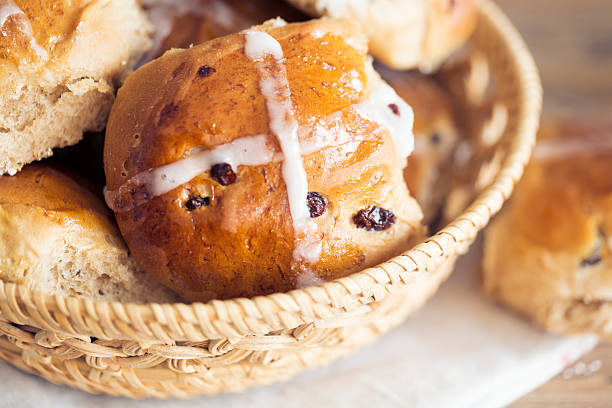 A plate full of freshly baked hot cross buns for the Easter holidays on an isolated white background. A view from above looking down.