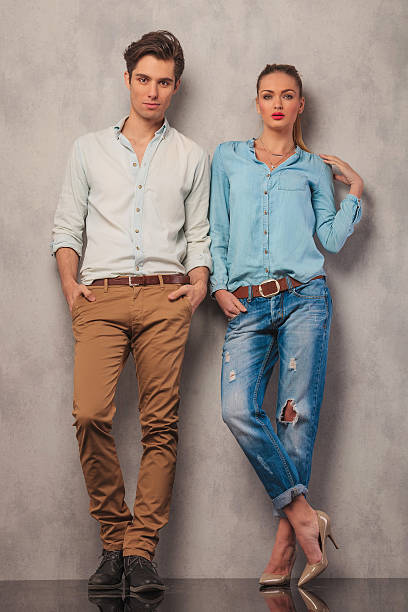 istock couple standing in studio posing with hands in pockets 509092378