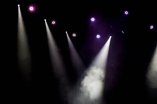 Concert venue with spotlights and fog from a fog mashine.