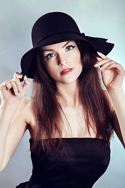 istock Woman in black dress and hat 509094088