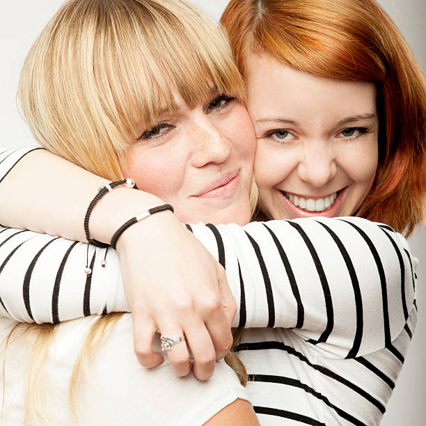 istock red and blond haired girls laughing and hug 509095826