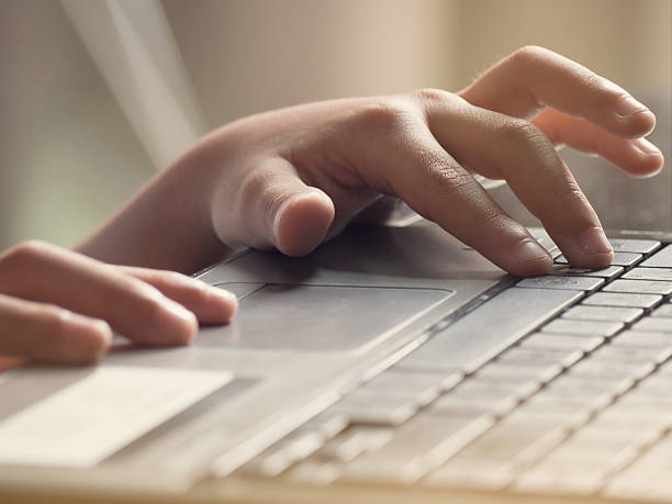 istock asian kid is typing on a laptop by his hand. 509095972