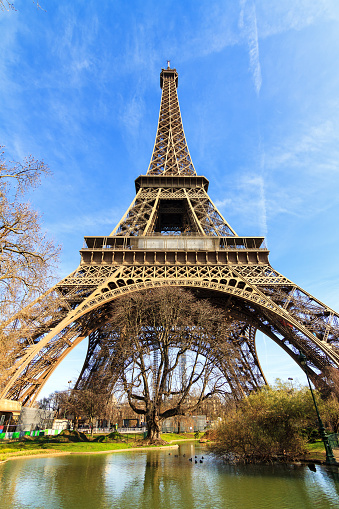 Beautiful view of the Eiffel tower seen from the park close at it in Paris