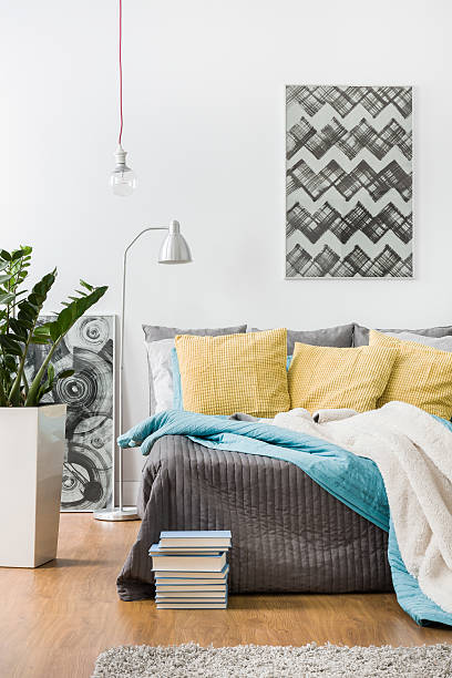 istock Yellow cushions and gray bedspread 509096122
