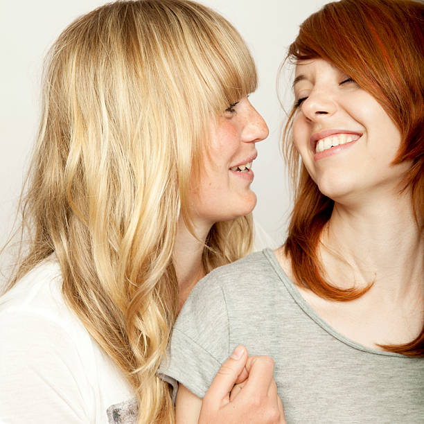 istock blond and red haired girls are laughing 509096528