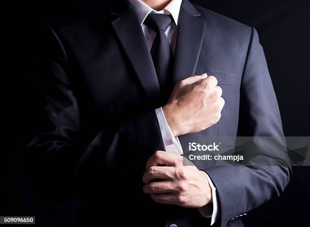 Businessman Fixing Cufflinks His Suit Stock Photo - Download Image Now - Adjusting, Necktie, Men