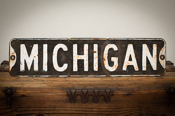 Color stock photo of an old, rusty hand-painted street sign reading 