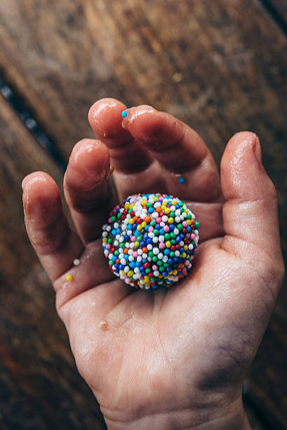 small hand holding brazilian brigadeiro praline