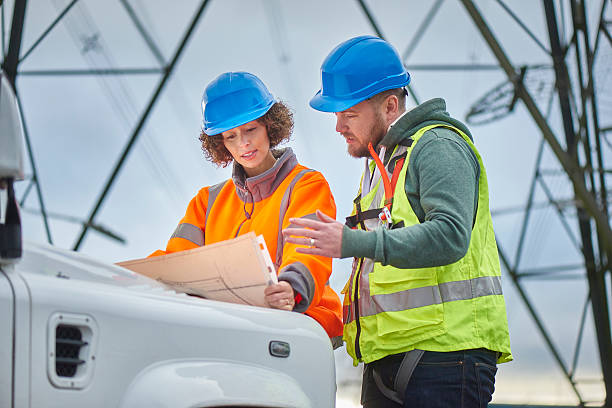 istock electricity engineers and contractor beneath an electricity pylon 509103192