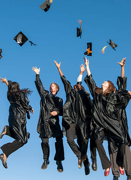 istock College Graduates Jumping and Tossing Their Caps 509105400