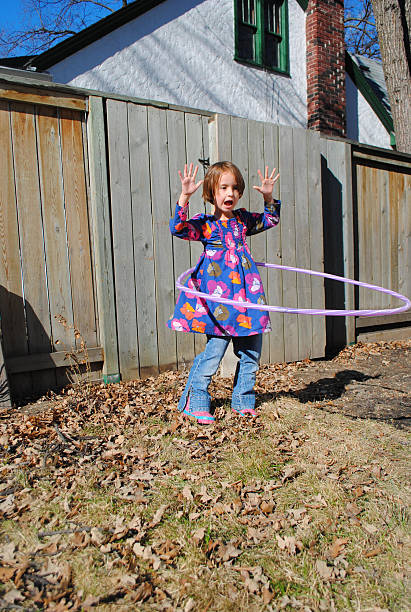 istock Young girl spinning a hula hoop 509108162